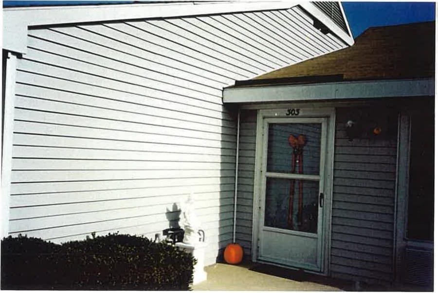 A single-story Stevensville Village apartment home with light siding and a private front entrance